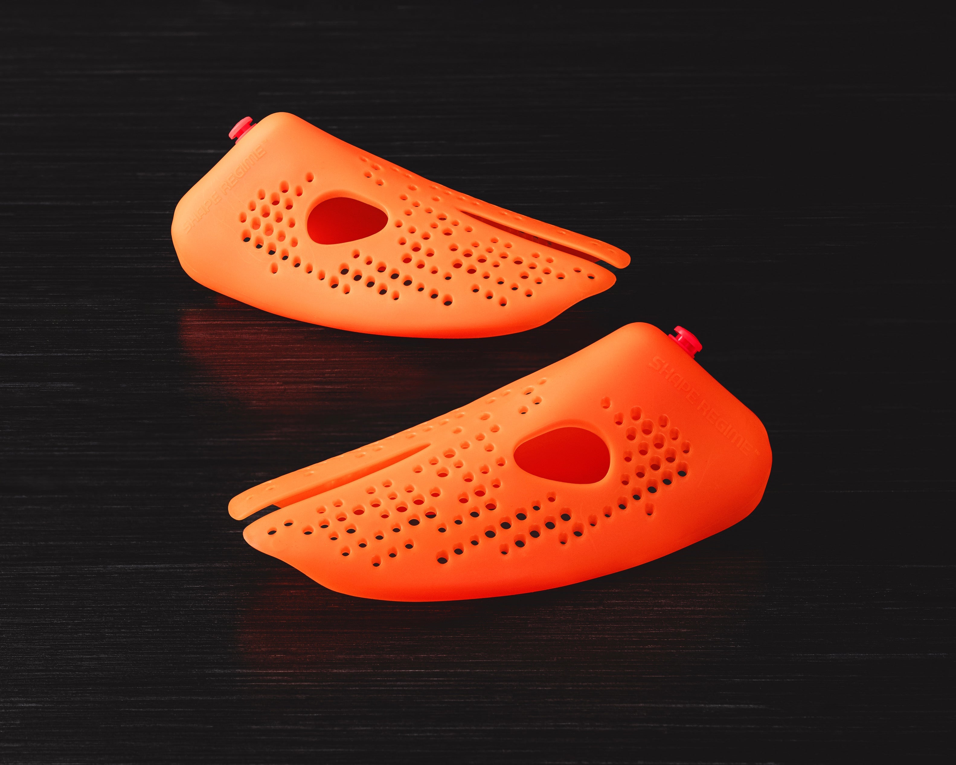 Stinky Sneakers shoe inserts in orange designed to eliminate odor from footwear and keep shoes fresh.