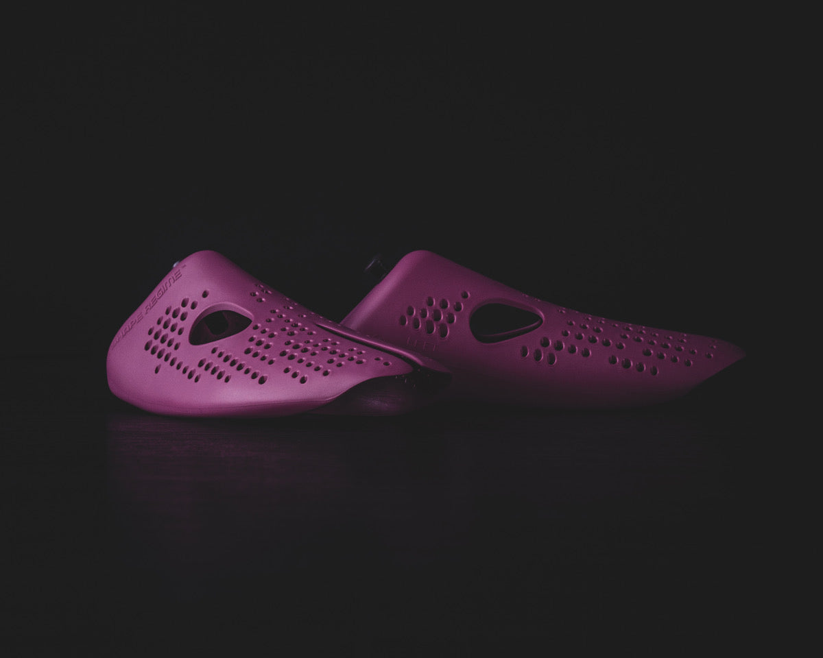 Odor-removing shoe insert in glossy purple color, designed to eliminate odors from smelly shoes.