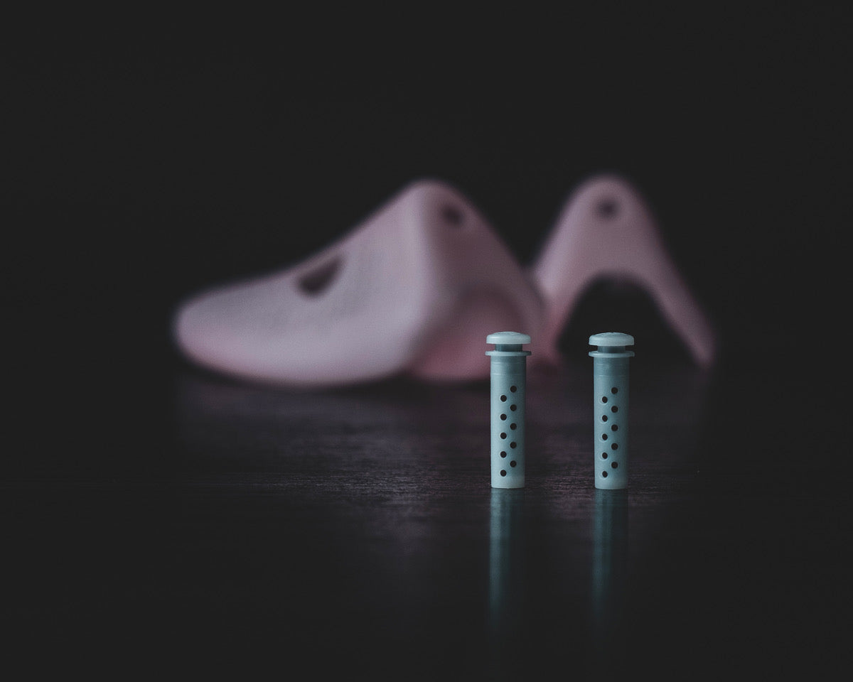 Odor-Removing Shoe Insert for Smelly Sneakers showcased with sneaker molds in the background.