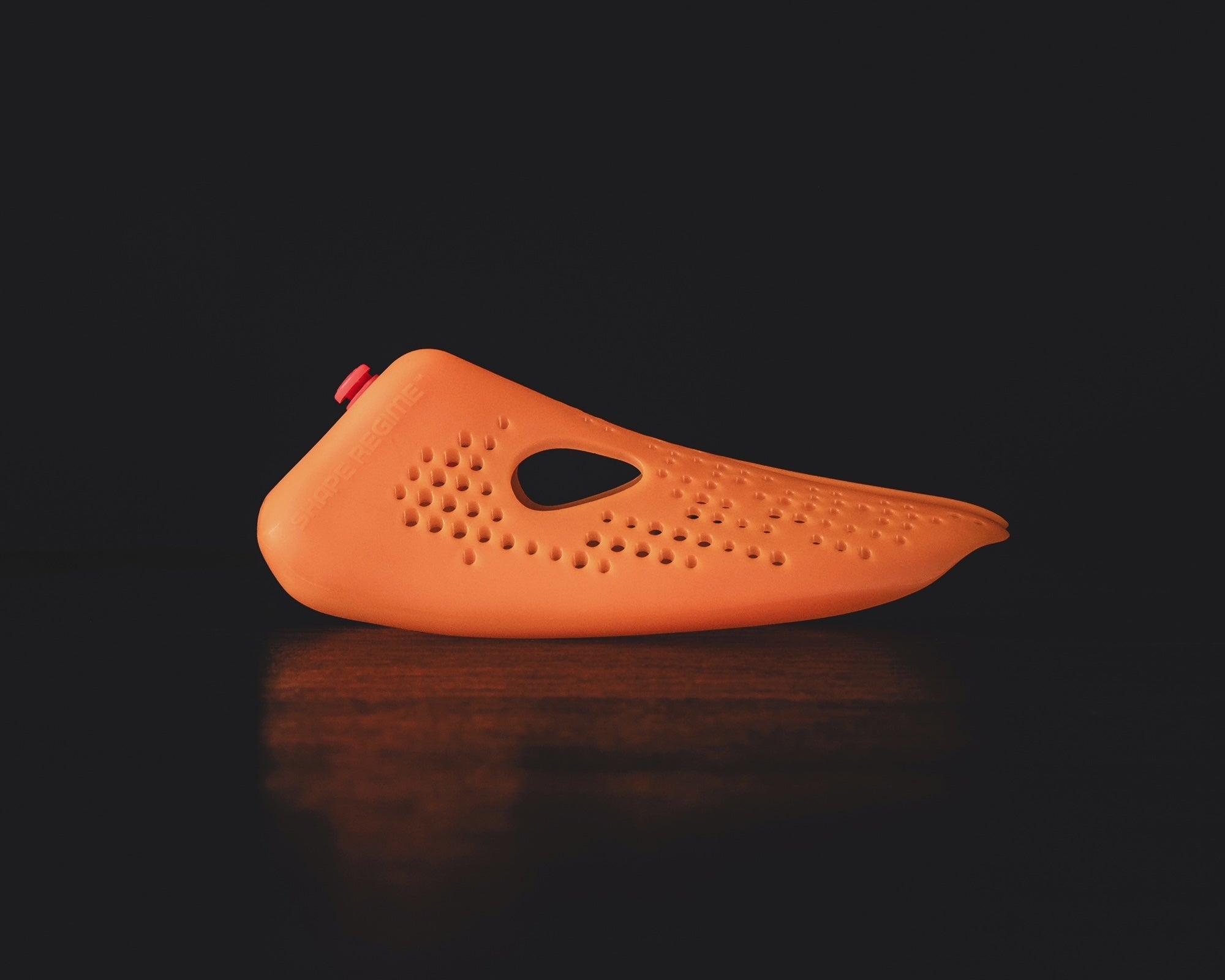 Stinky Sneakers shoe insert in bright orange designed to eliminate odors for fresh footwear.