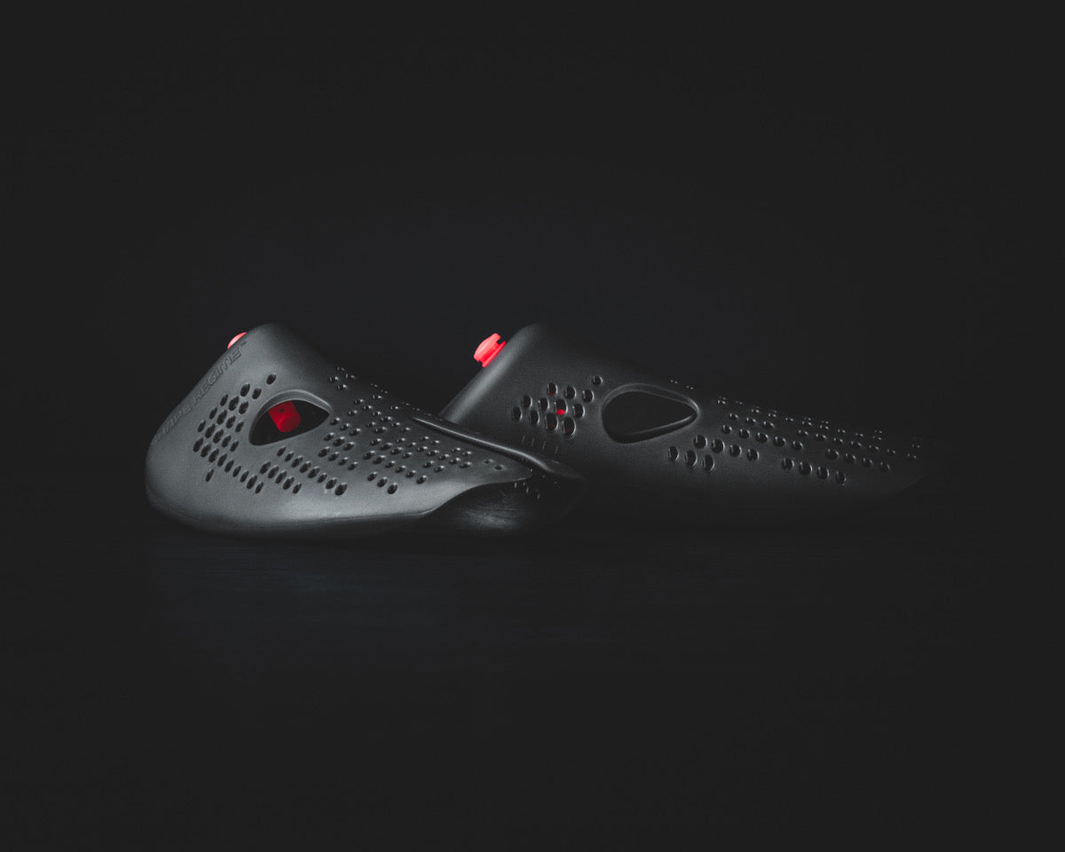 Odor-removing shoe insert designed for eliminating smells in shoes, featuring a sleek black design and red details.